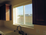 Closeup of the blinds in the kitchen window.